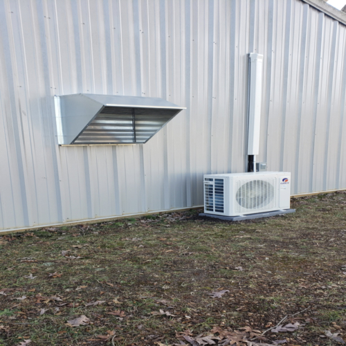 a mini split on the outside of a barn