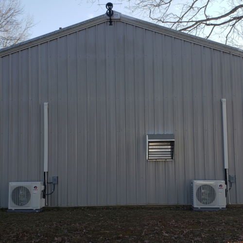 two mini splits on the outside of a barn