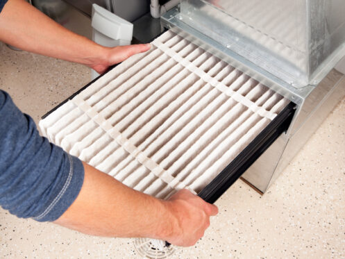 A man changing the furnace filter in Zebulon, NC